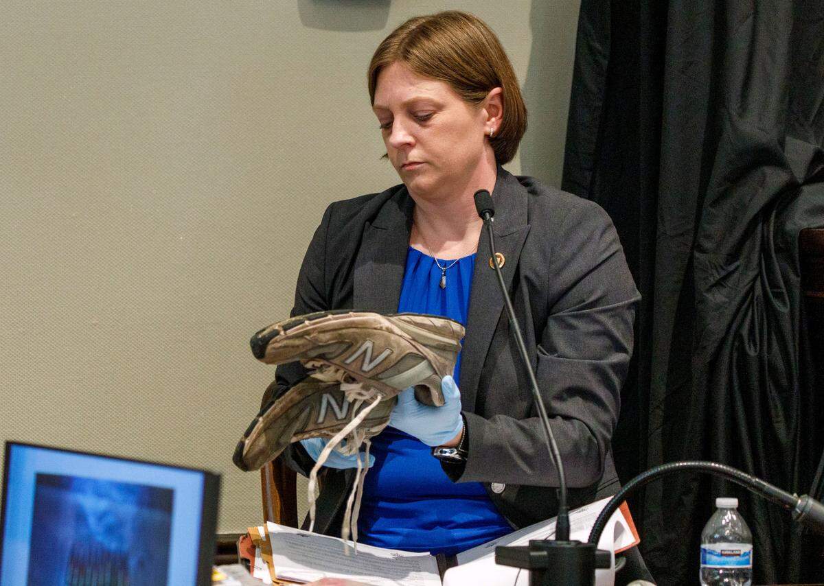 Witness SLED agent Melinda Worley handles the shoes of Paul Murdaugh that were collected into evidence in the double murder trial of his father Alex Murdaugh at the Colleton County Courthouse in Walterboro, Friday, Jan. 27, 2023. Grace Beahm Alford/The Post and Courier/Pool
