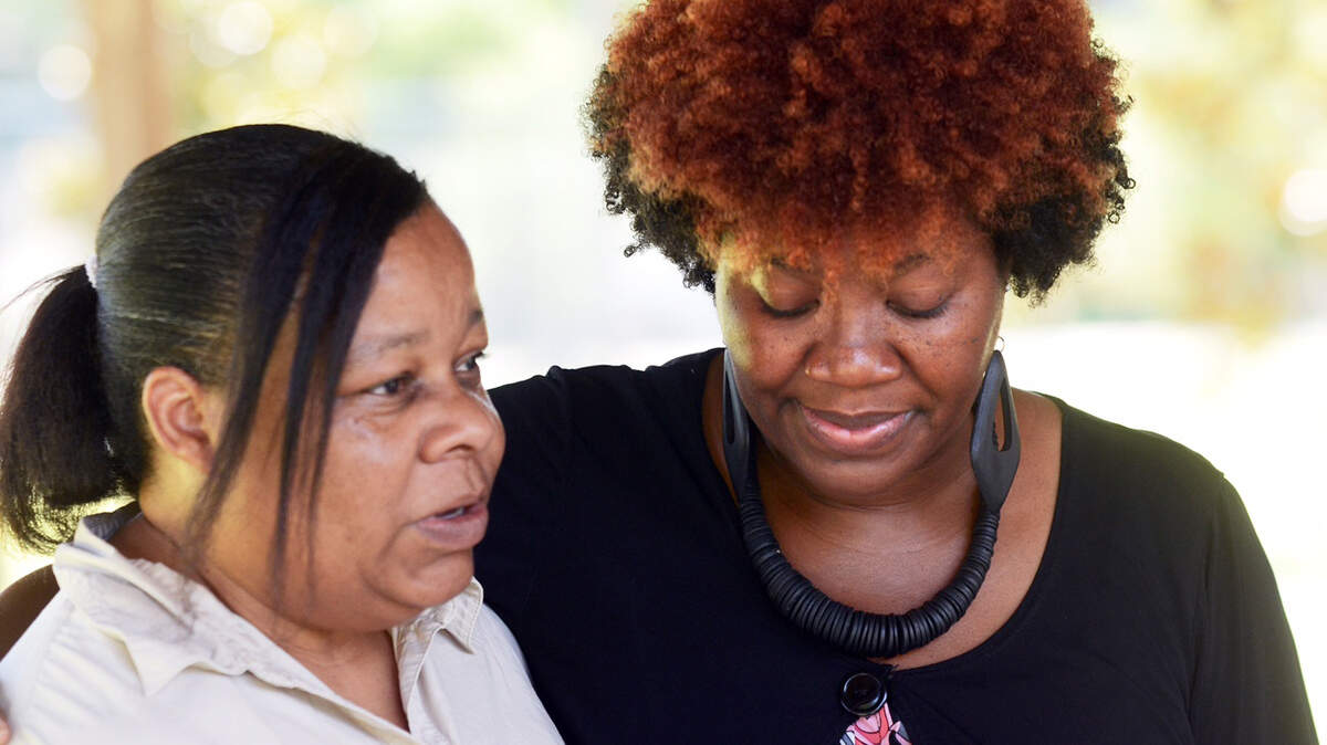 Biner Lawyer-Green, left, of Robertsville, S.C., and Topeka Williams, of Hardeeville, console each other during a special Prayer in the Park service at Ridgeland's Harold Turpin Park on Thursday. The service was held for the nine victims of Wednesday's shooting at Charleston's Emanuel African Methodist Episcopal Church, which included the church's pastor Clementa Pinckney, who was also a state senator from Ridgeland. Both Lawyer-Green and Williams attended high school with Pinckney. "I couldn't believe it," said Williams of the news. "It doesn't seem real ... we've got to come together," said Lawyer-Green.