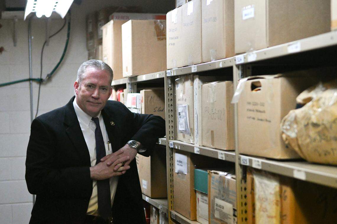 Maj. Bob Bromage, cold case detective with the Beaufort County Sheriff’s Office, poses in the sheriff’s office’s evidence room, among boxes of evidence collected in the investigation of homicides that have not yet been solved.