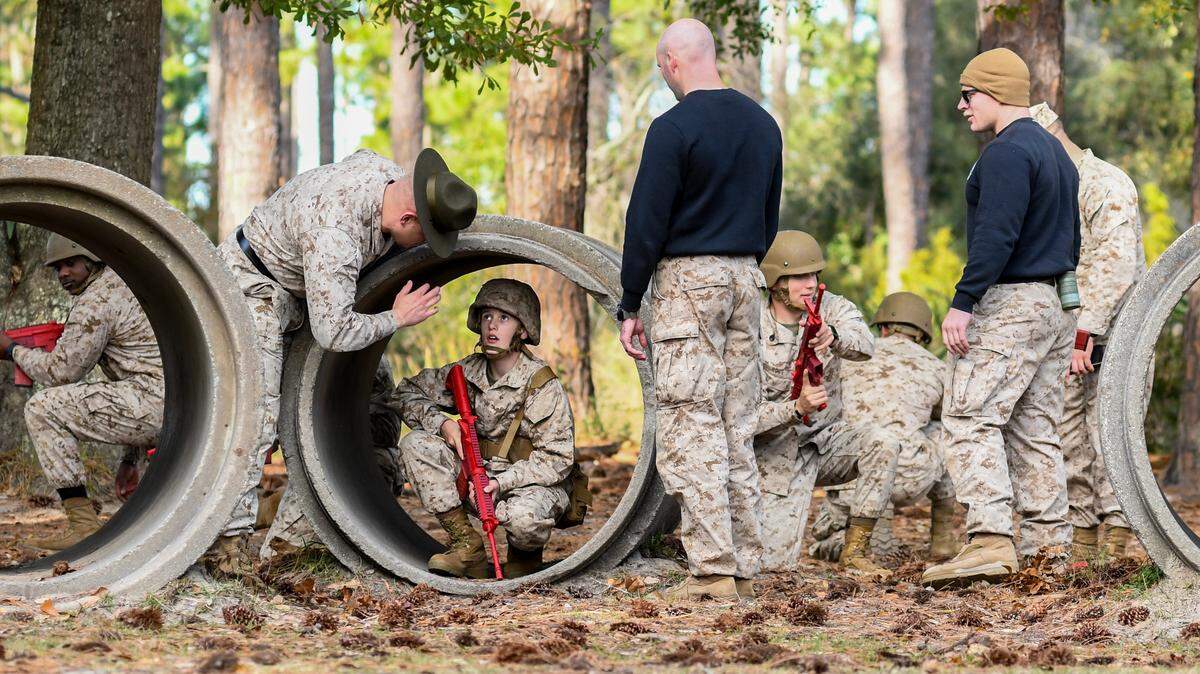On the Day Movement Course, drill instructors explain how Trent Williams, 12, should move though the cylinder checking for wires that may be attached to a concealed explosive device on Thursday, Dec. 14, 2023, at Marine Recruit Depot Parris Island. Trent spent the day training as a Marine as part of the Make-A-Wish Foundation. Trent has hypoplastic left heart syndrome, a rare congenital birth defect that affects normal blood flow through his heart.