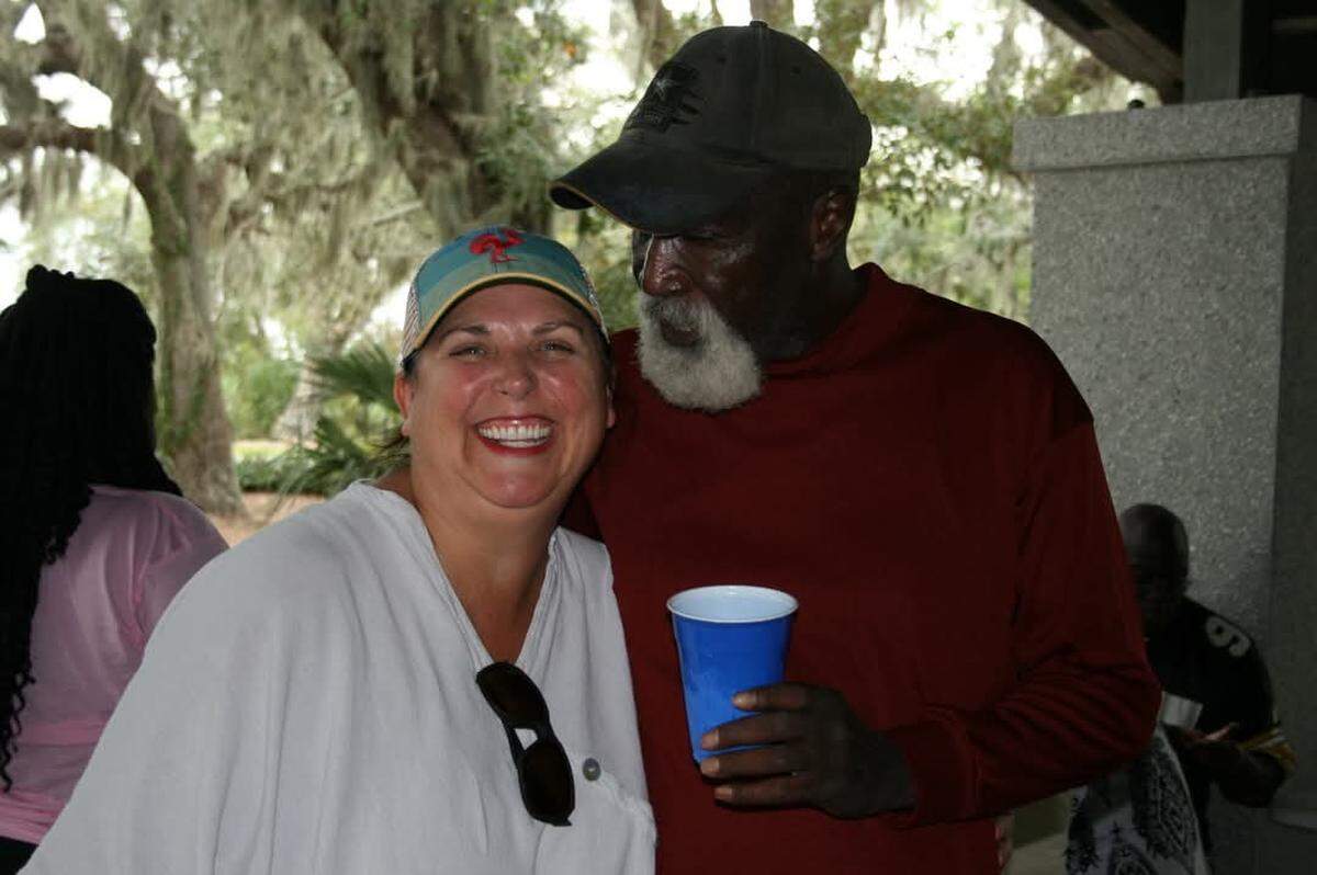 Heather Rath and Ben Green smile together for a photo at his 70th birthday party.