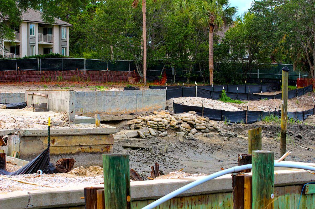 Piles of sandbags lay by concrete bulkheads at the South Beach Marina Village on May 30, 2025.