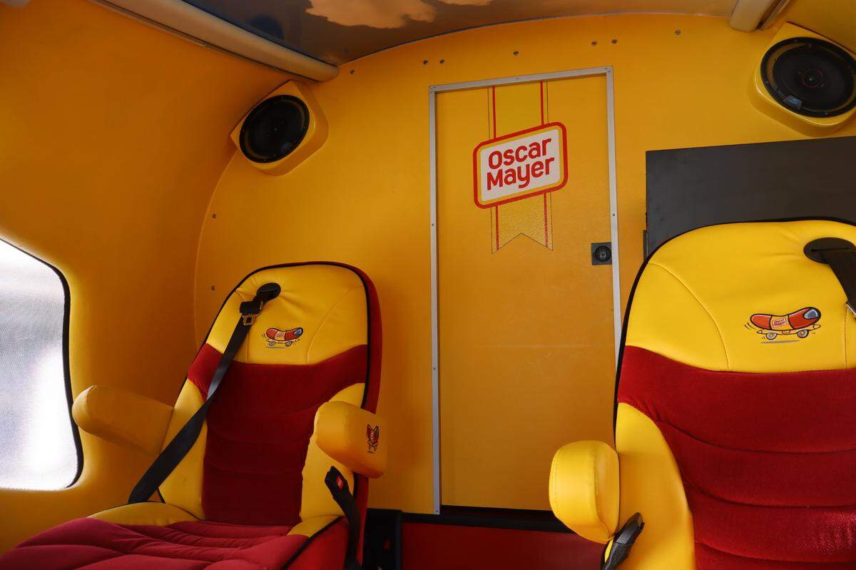 The interior of an Oscar Mayer Wienermobile is decked in red and yellow, featuring cartoon renditions of the iconic brandmobile on each of its six seats. The 27-foot vehicle was scheduled to make four stops in Hilton Head Island and Bluffton beginning March 13, 2025.