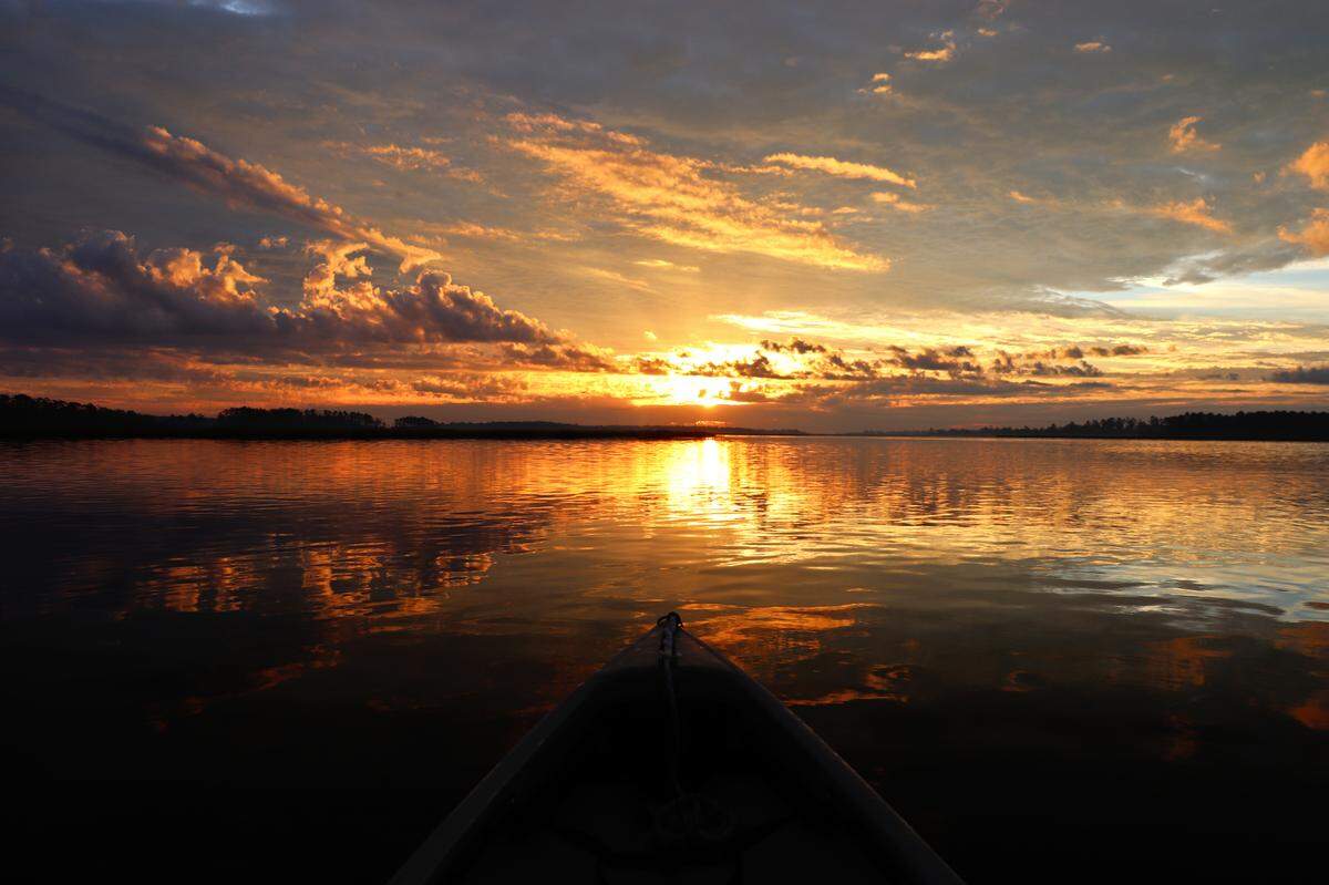 An early morning kayak trip can provide a tranquil setting to enjoy nature in all its glory. Here the sunrise over Wimbee Creek in northern Beaufort County seems to put the day ahead and even life itself into perspective.