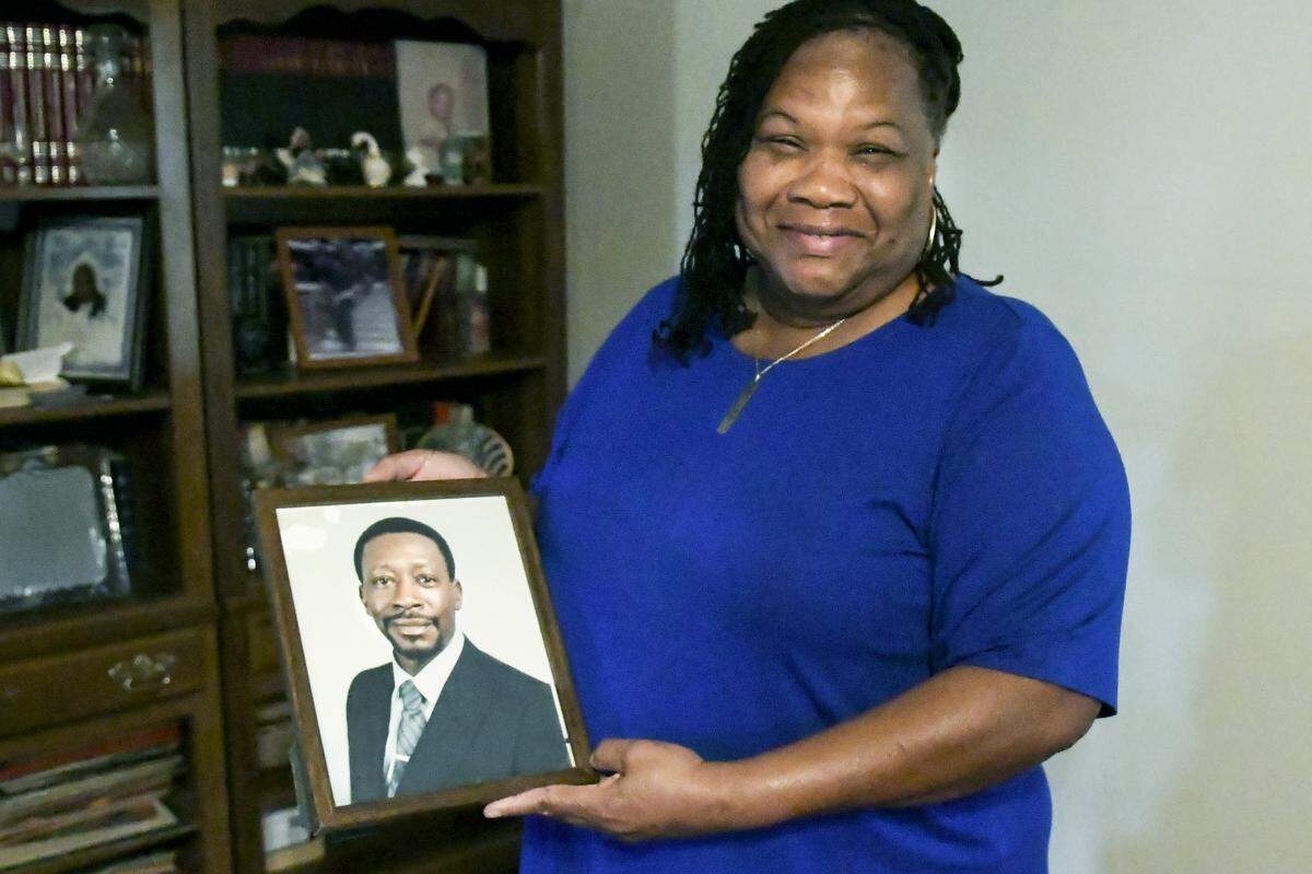 Claretha Singleton holds a photo of her husband, William Singleton on November 14 at her home on St. Helena Island, a Vietnam War Veteran who died in 1999 from Agent Orange disease. Singleton was receiving her prescriptions from Beaufort Naval Hospital for more than 12 years when, according to Singleton, a new computer system flagged her as ineligible noting she owed the federal government more than $10,000. On Tuesday, Singleton received word that she would be reimbursed.