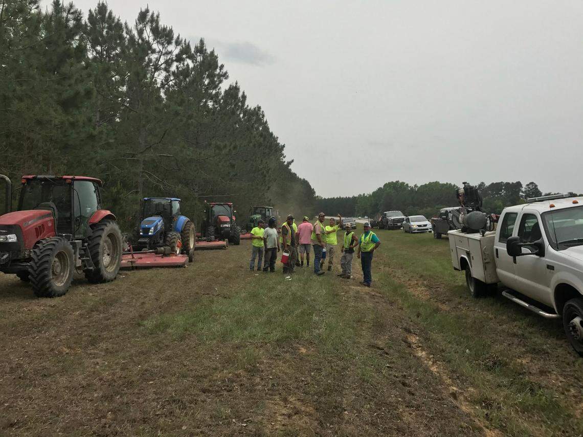 H-2B workers at Maddox Contractors, which contracts with South Carolina Department of Transportation to complete roadside mowing projects in Jasper and Hampton Counties, take a quick break from work.