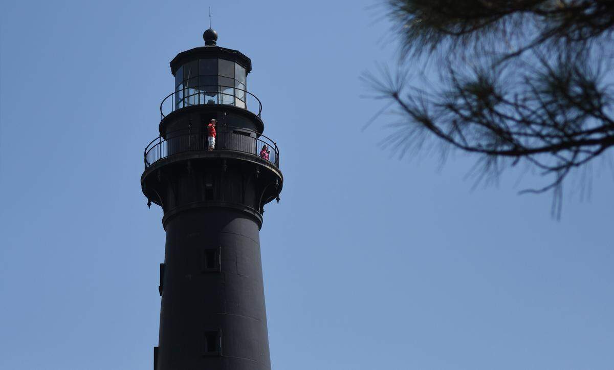 Visitors take in the view from the observation deck of the Hunting Island lighthouse in this file photo. After a structural assessment, state park officials plan $3 million of work to reinforce the structure.