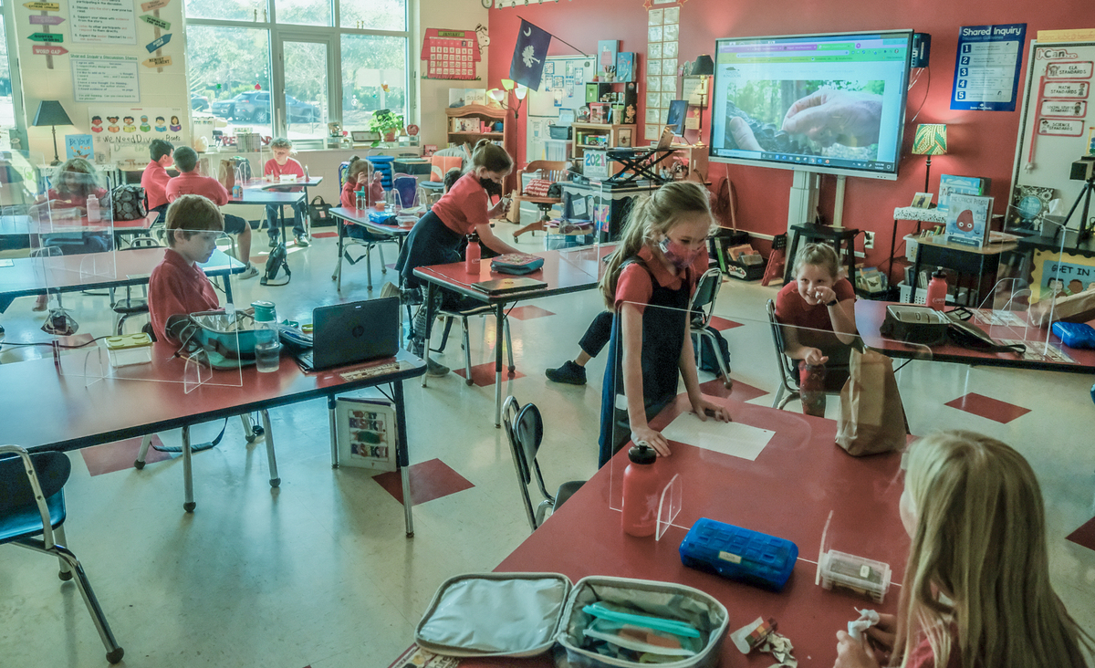 Plastic barriers separate third grade students as they finish their lunch in their classroom on Monday, Jan. 4, 2021 at Red Cedar Elementary School in Bluffton. Lunchtime and recess are the only times a student gets a reprieve from wearing a face covering as the district began full in-person instruction after the coronavirus pandemic forced remote instruction about a year ago.