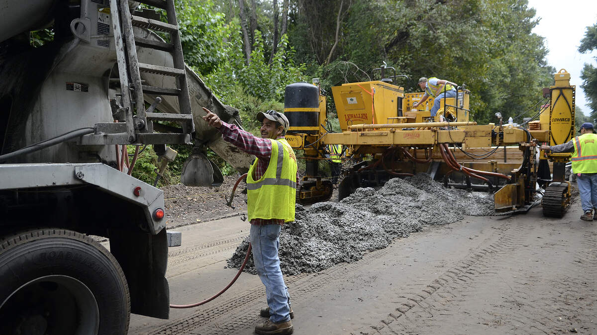 Armando Nurguia, a foreman with Lewallen Construction, gives instructions as concrete is poured to make the trail on the Spanish Moss Trail on Thursday afternoon near West Vine Road in Beaufort.
