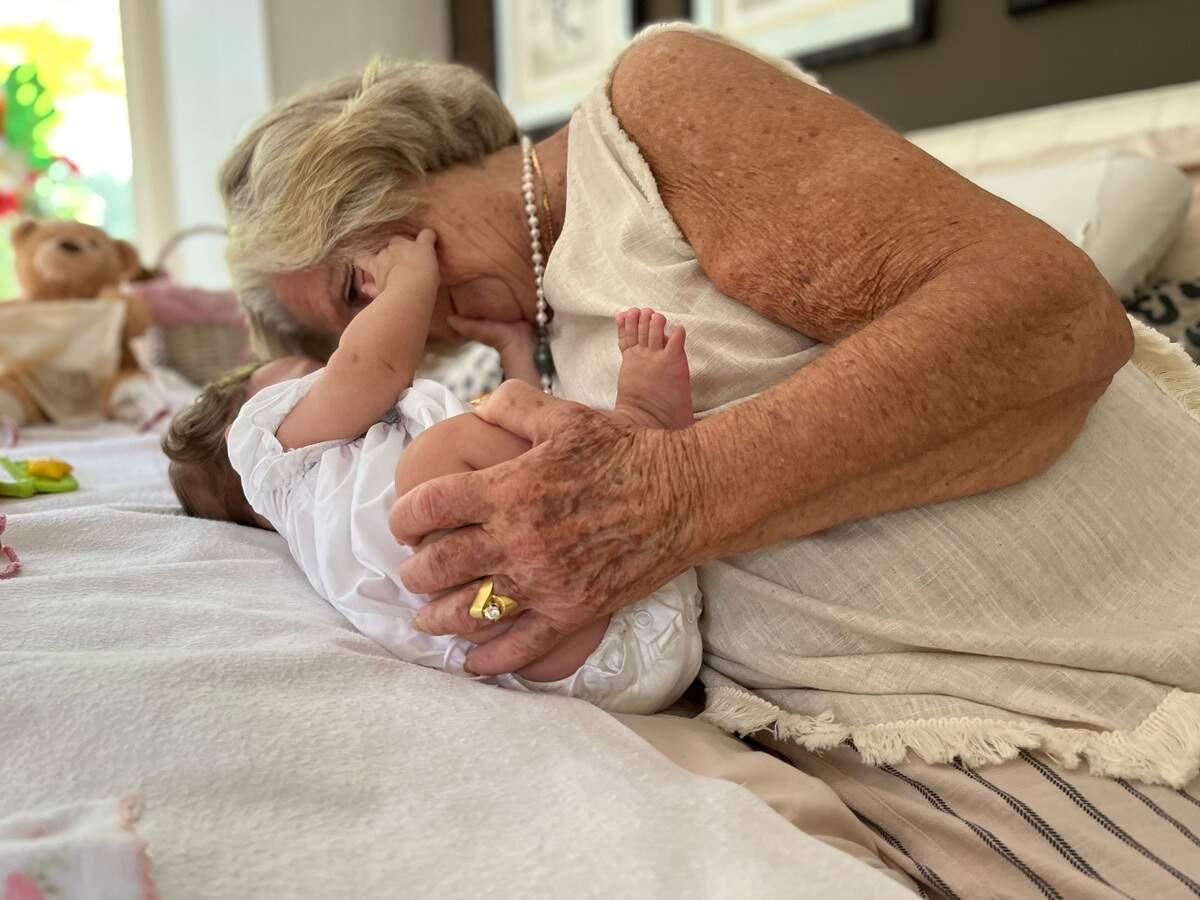 Van Name cuddles her newest foster baby, a 5-month-old baby girl. Together, the two enjoy walks around the neighborhood, apple sauce and playing with Van Name’s toy collection.
