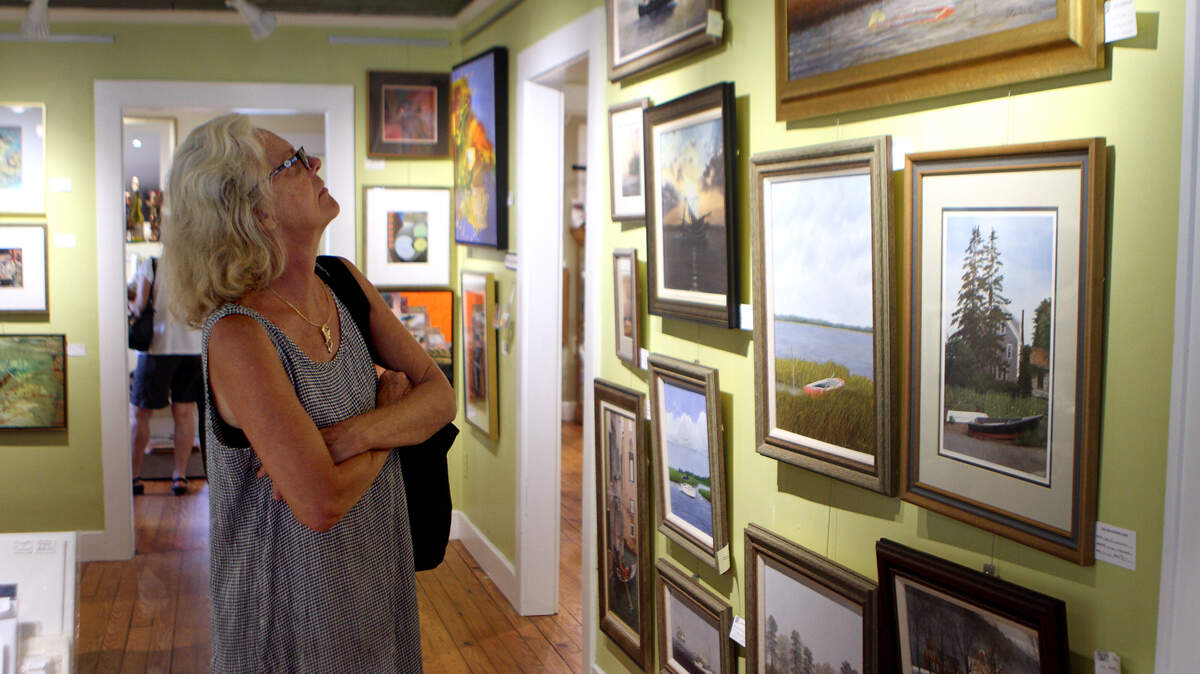 File: Karen Palmer, of Hilton Head Island, looks at some of the art work at Pluff Mud Art Gallery on Sept. 10, 2015, in Bluffton.