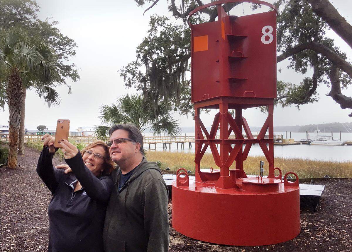Kelli and Bill Normoyle, of Bluffton, were on hand to watch the replica of Coast Guard Buoy No. 8 be put in place at Skull Creek Dockside restaurant on Friday and thus were among the very first people who were able to take a selfie with the new attraction located next to the restaurant’s outdoor bar on Skull Creek. The two said they were reenacting the selfie they took last September with the original buoy, which washed up on Hilton Head’s South Forest Beach after Tropical Storm Irma and became quite the unintended tourist attraction until if was finally removed a couple of months later.