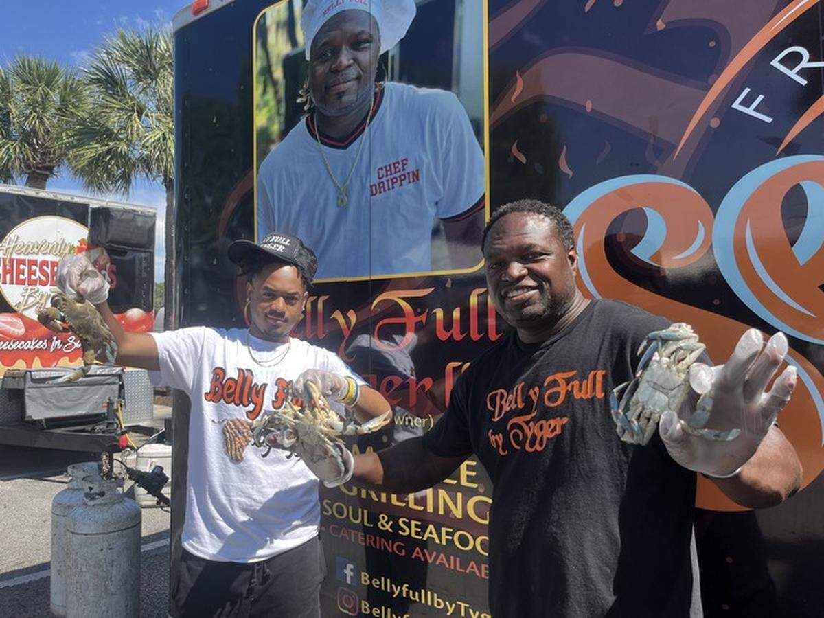 Reaqwon Cohen and Tyger Snell hold up blue crab they’ll be selling at the the Belly Full by Tyger food truck this weekend at The Original Gullah Festival. Snell owns the business. Cohen is general manager.