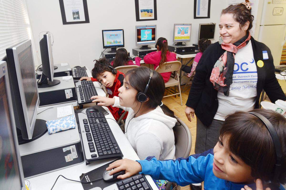 Teresita Perez looks on as her daughter, Ruth Perez, 9, flanked by brothers Aaron Ortiz, 7, foreground, and Carlos Ortiz, 6, uses one of the computers in the Neighborhood Outreach Connection’s Virtual Learning Center at The Oaks on Hilton Head Island. The 2013 addition to the NOC’s facilities was made possible by a $75,000 grant from the Van Landingham Rotary Club, which spent two years raising the money according to John Farrenkopf, of the club.