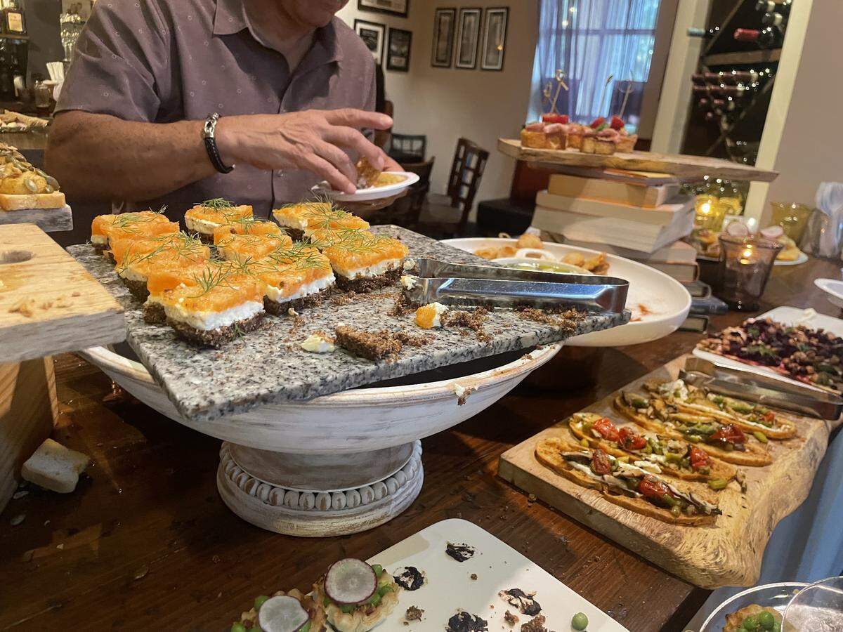 At a wine social event at Mulberry Street Trattoria, Chef Chris Sullivan served small bites for guests, including smoked salmon cheesecake on pumpernickel bread.