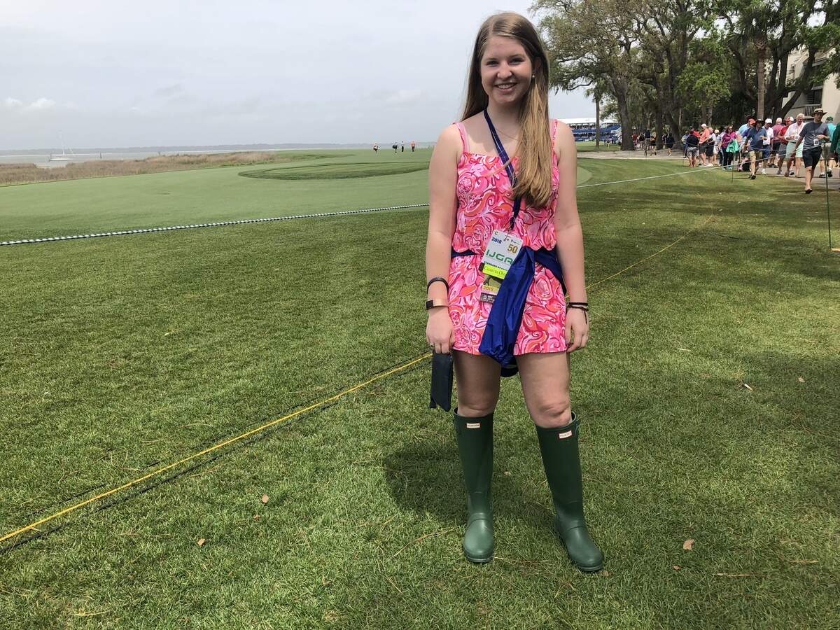 Ella Alsko, a sophomore at Hilton Head Preparatory School, paired her bright pink dress with rain boots on Sunday in preparation for possible thunderstorms.