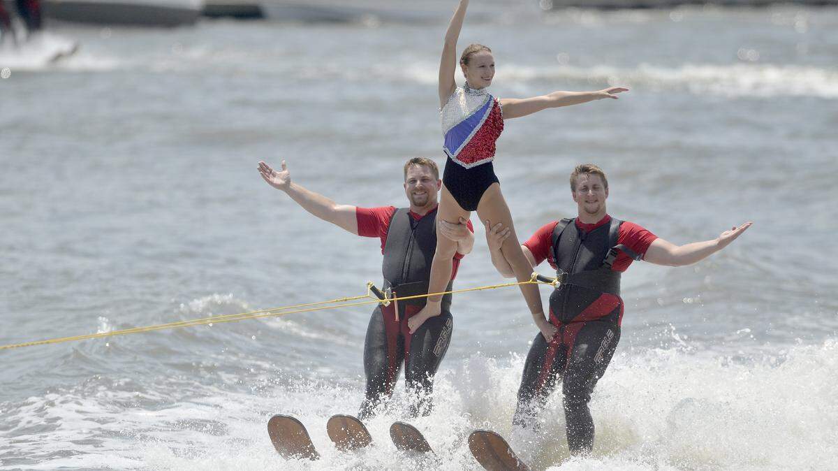 Performers with the Gatorland Water Ski Show Team smile toward the audience during their show on Saturday afternoon on the second day of the 60th Beaufort Water Festival at Henry C. Chambers Waterfront Park in Downtown Beaufort.