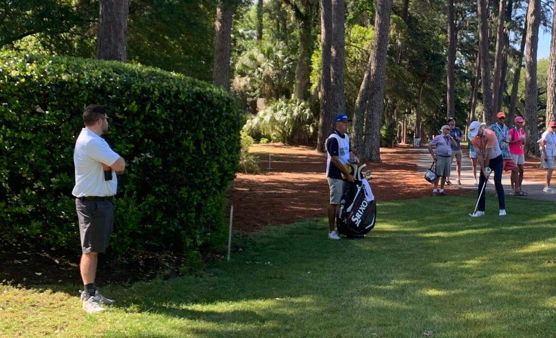 Chad Dewing watches as a golfer take a shot mere feet from his father-in-law’s backyard in Sea Pines.
