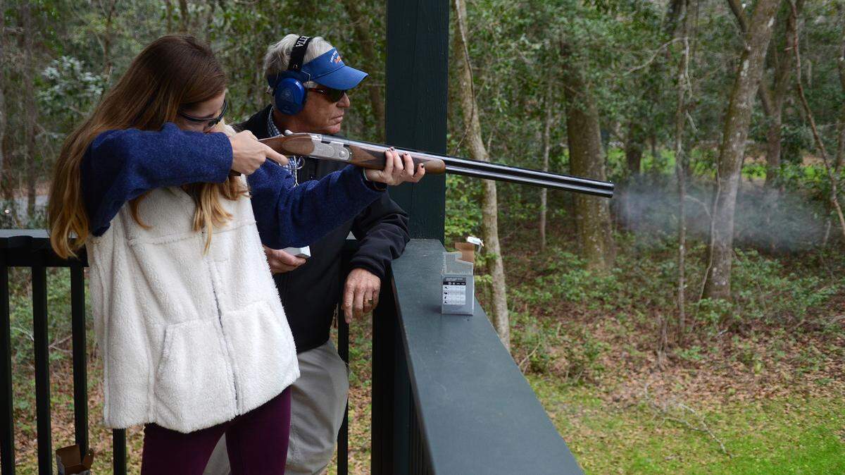 Catie Meighan, 15, of Bluffton, uses a shotgun for the first time Sunday after getting a quick lesson from Fuzzy Davis during a preview event for the new shooting course at Palmetto Bluff in Bluffton.
