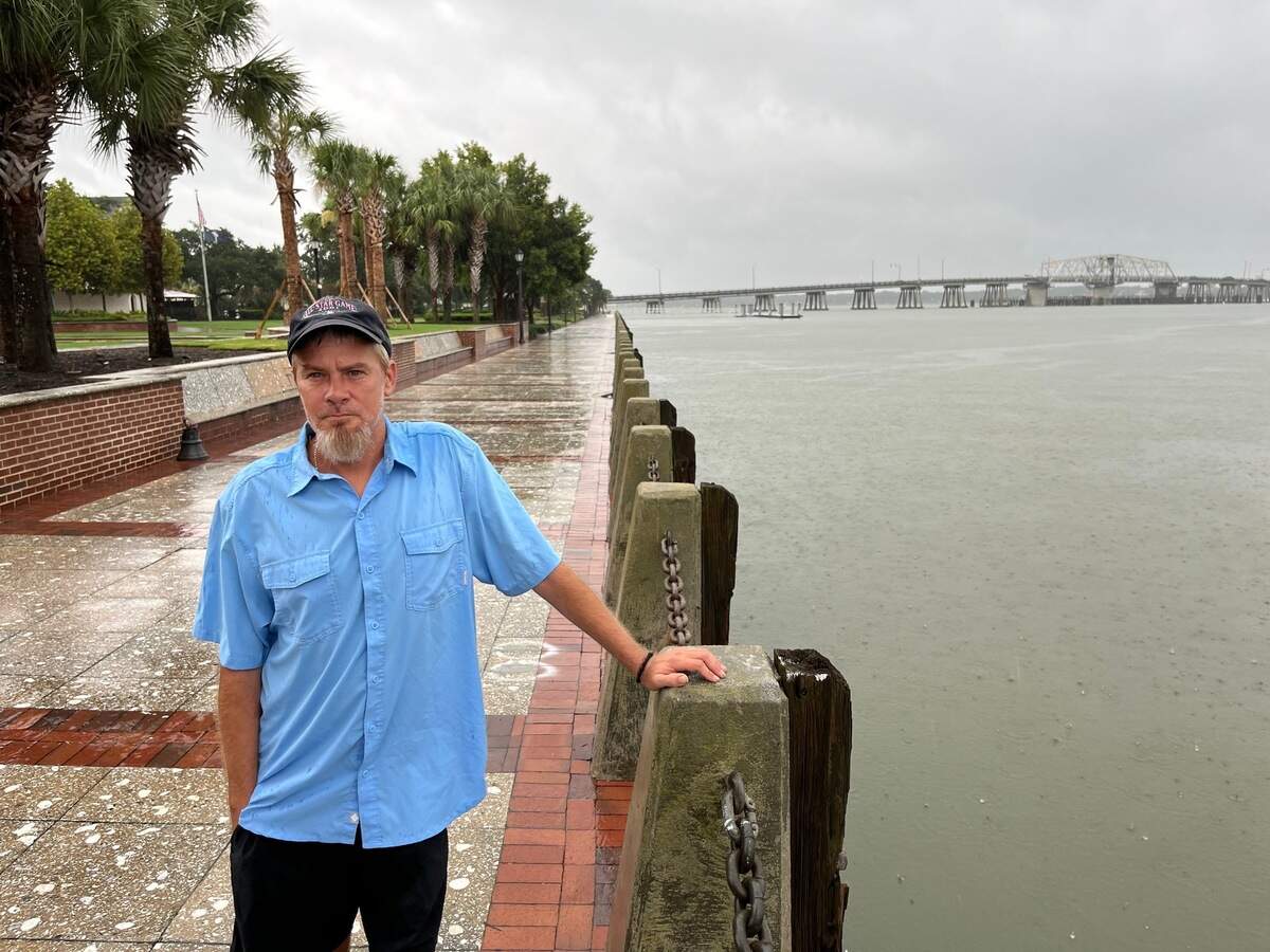 Jason D., who lives outside, stands by the Beaufort River at Waterfront Park in Beaufort Wednesday morning. He said he plans to head to a rooftop in downtown Beaufort to ride out the rising waters.
