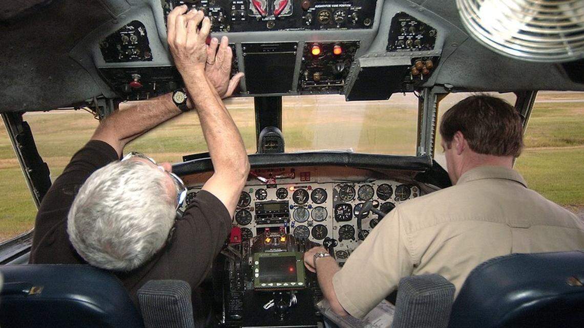 Command pilot Julian Hill, left, and chief pilot Rob Wright start the engines of Beaufort County’s converted Convair C-131F mosquito plane Thursday morning before a spraying mission over the barrier islands of northern Beaufort County. Wright said they fly early in the morning when the air is cool and calm.