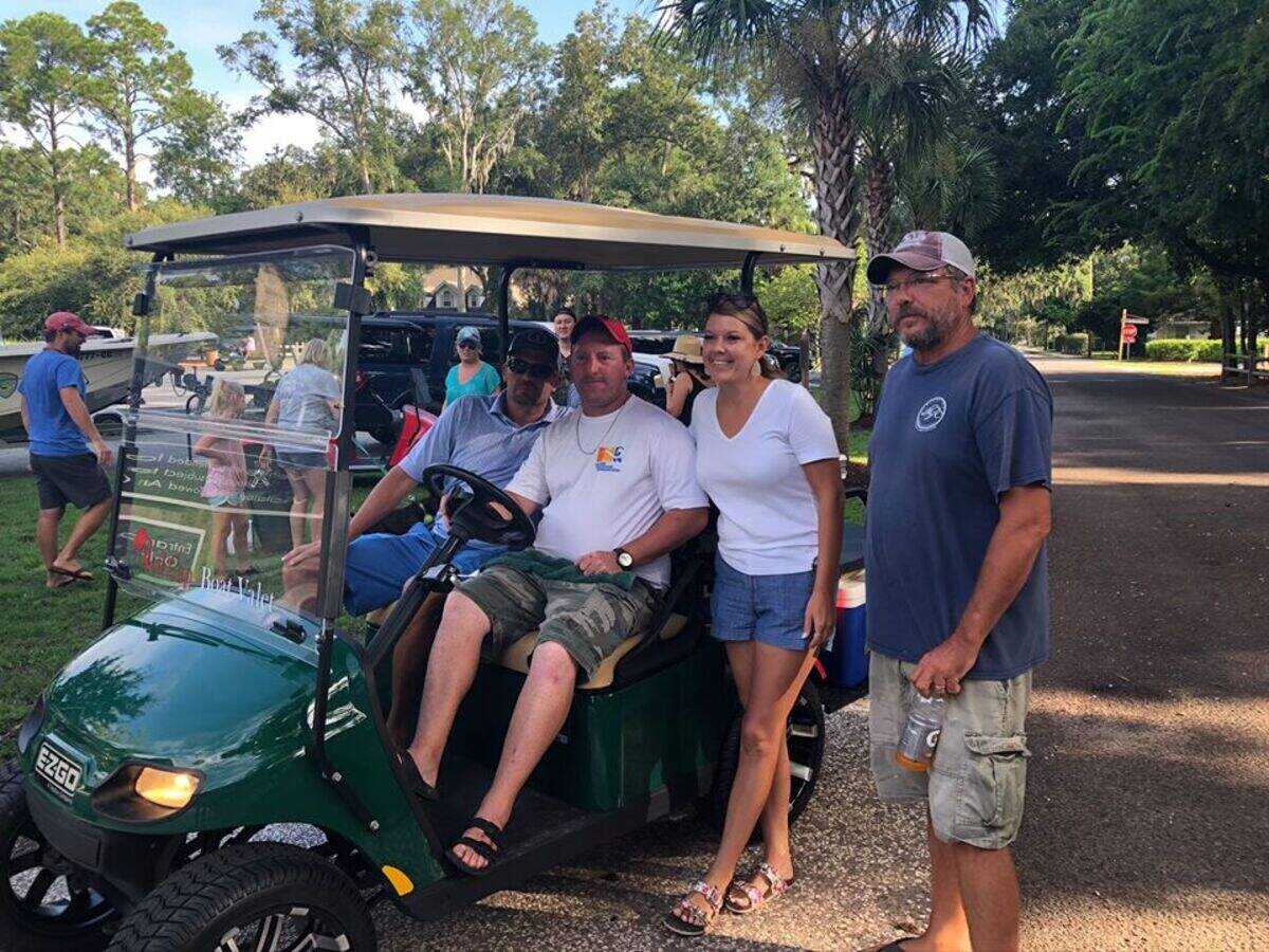 Jeffrey Gainey, center, received a new golf cart to help him organize traffic at the Bluffton Oyster Factory boat landing.