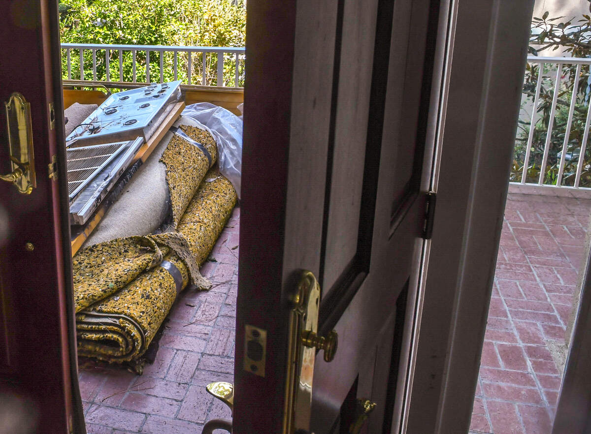 At the front door, water and smoke damaged carpet along with the cooktop that started the fire remain on the front porch of Danielle Smith’s Jenkins Island home. Smith says the insurance company won’t let her remove the fire-damaged goods until insurance inspectors have completed their analysis.