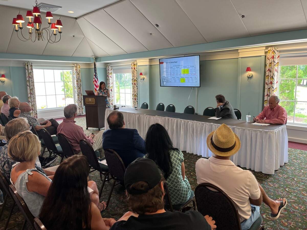 Xiaodan Li, who organized Friends of Liberty, speaks Saturday at Indigo Run on Hilton Head Island where Gov. Henry McMaster, right, spoke during a campaign stop Saturday that drew at more than 160 people.