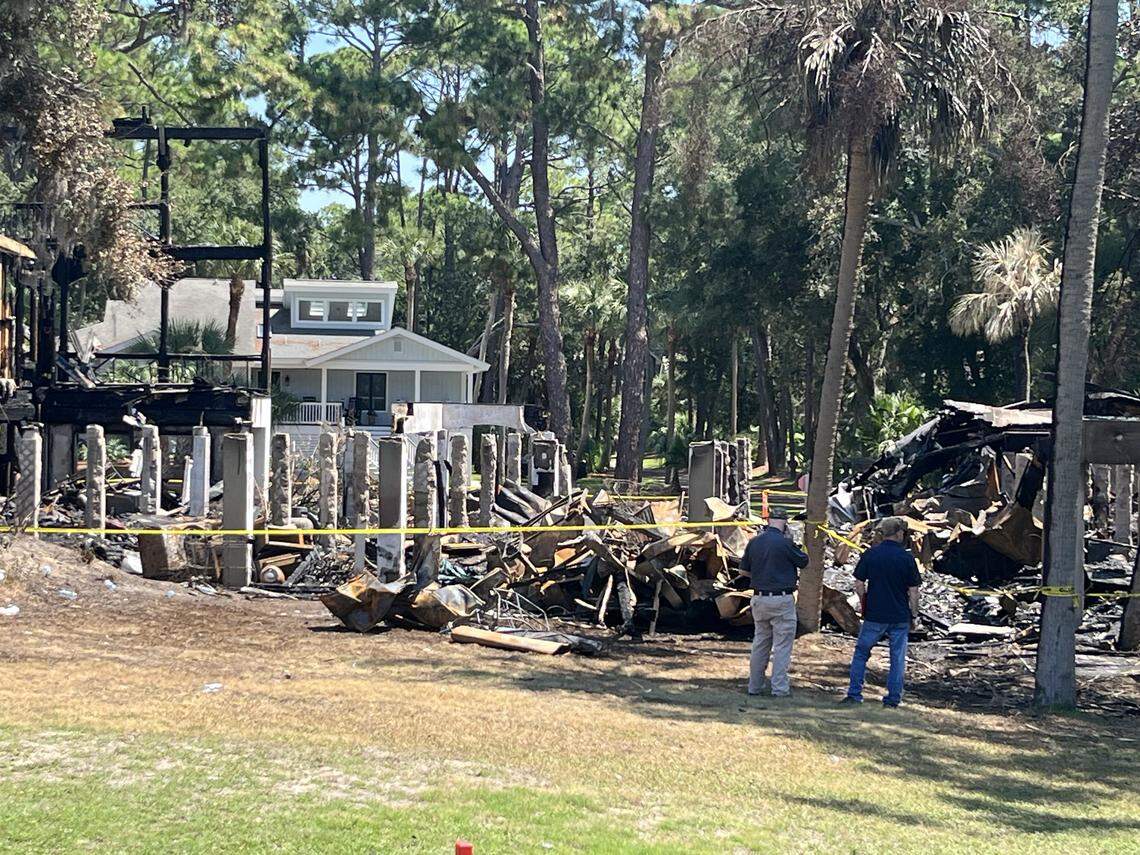Insurance adjustors inspect houses Monday on Bonito Road on Fripp Island. Three houses were destroyed in a Saturday fire.