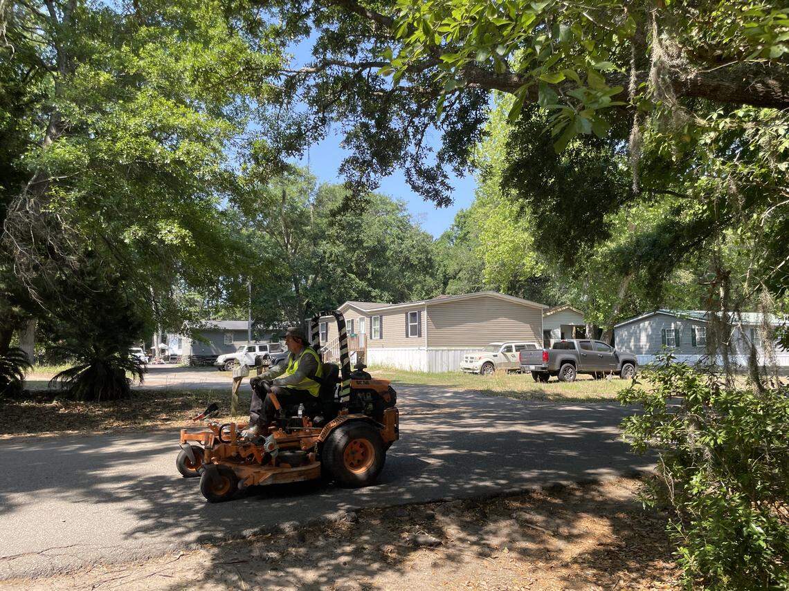 A landscaper drives through the Baygall neighborhood on Mitchelville Road, a quiet, shady neighborhood where people live in primarily manufactured homes.