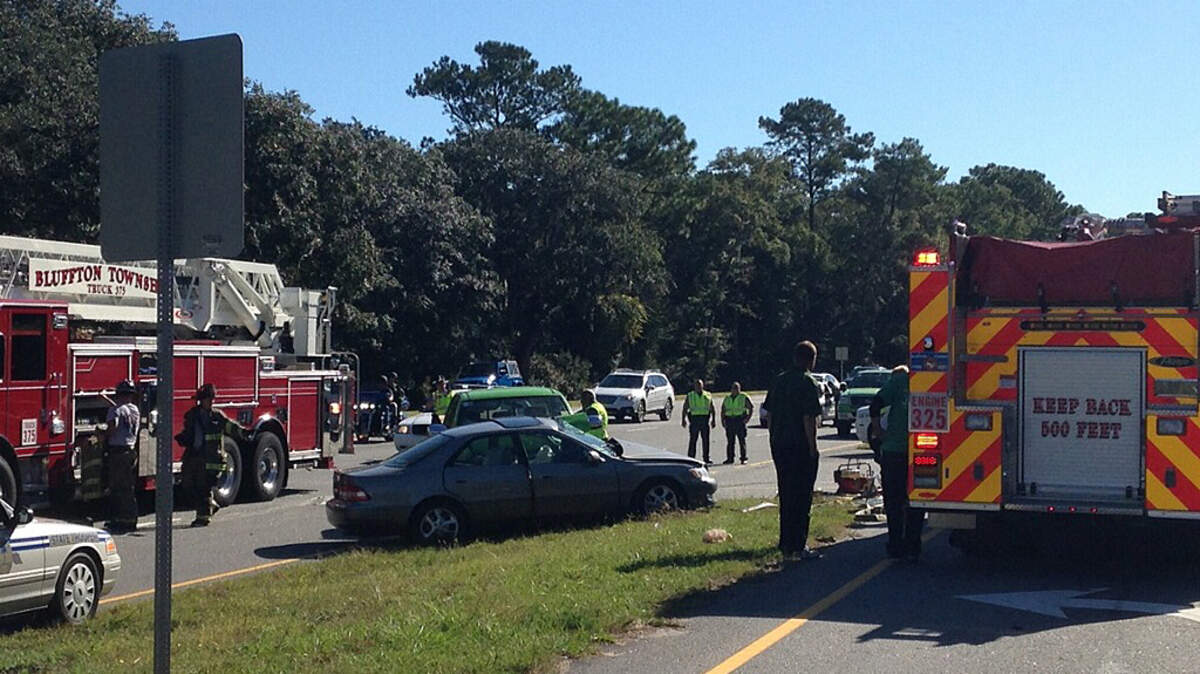 Bluffton Township Fire District and other emergency responders assess a wreck scene on US 278 near Pinckney Colony Road in Bluffton on Oct. 15, 2015. A medical helicopter transport was requested, requiring the closing of the highway in both directions.
