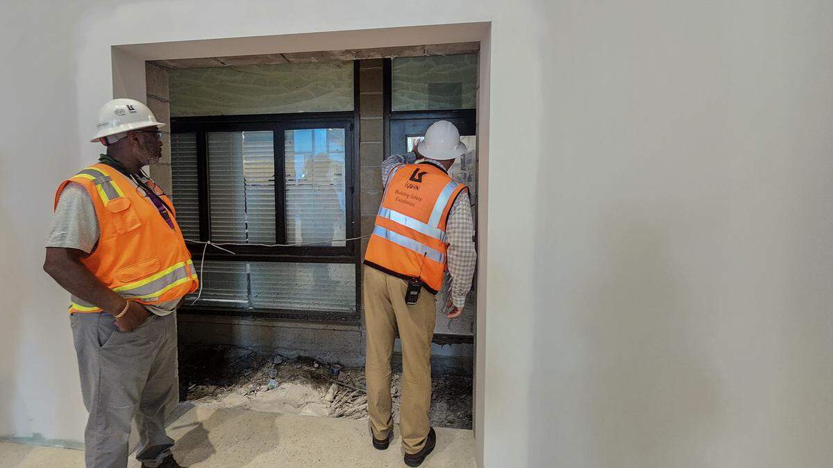 Steve Schidrich, right, principal of Hilton Head Island High School, waves to students in the fine arts building as project manager Tim Summers looks. Both stood in the hallway of the new Hilton Head Island High School as photographed on March 26, 2026, on Hilton Head. 