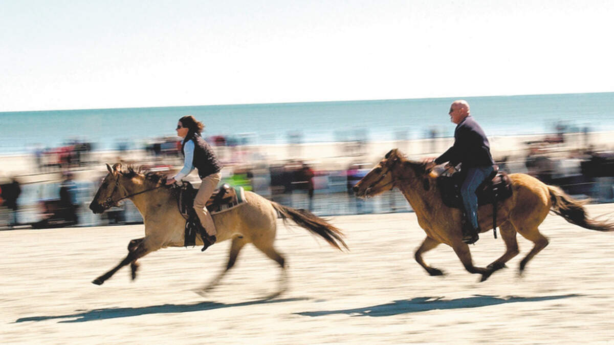 Riders race down a section of Coligny Beach on marsh tackies during the first heat of the second annual Marsh Tacky Run in February. The event showcased the history of the marsh tacky horse, a Lowcountry breed of stocky horses native to the Sea Islands.