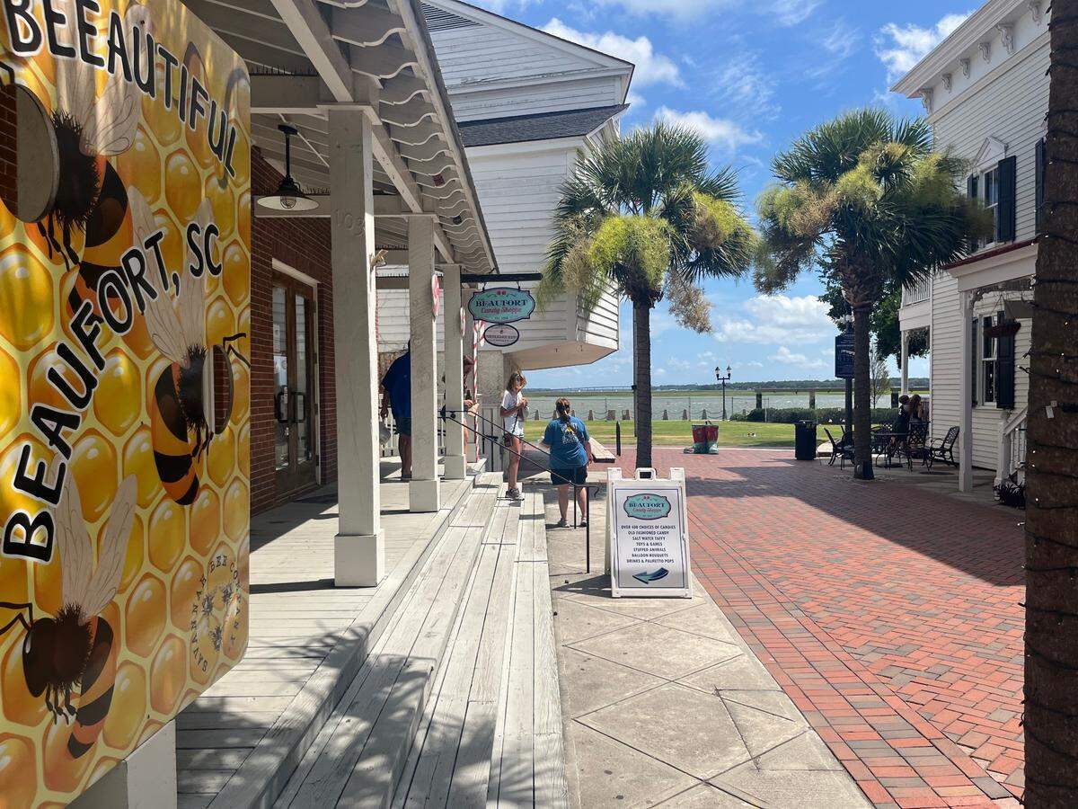 Customers leave a shop on the edge of Waterfront Park in Beaufort. Businesses note that they are still open for business, along with the majority of Waterfront Park, even though a sliver of the public gathering spot -- the promenade abutting the Beaufort River -- has been closed because of structural issues.