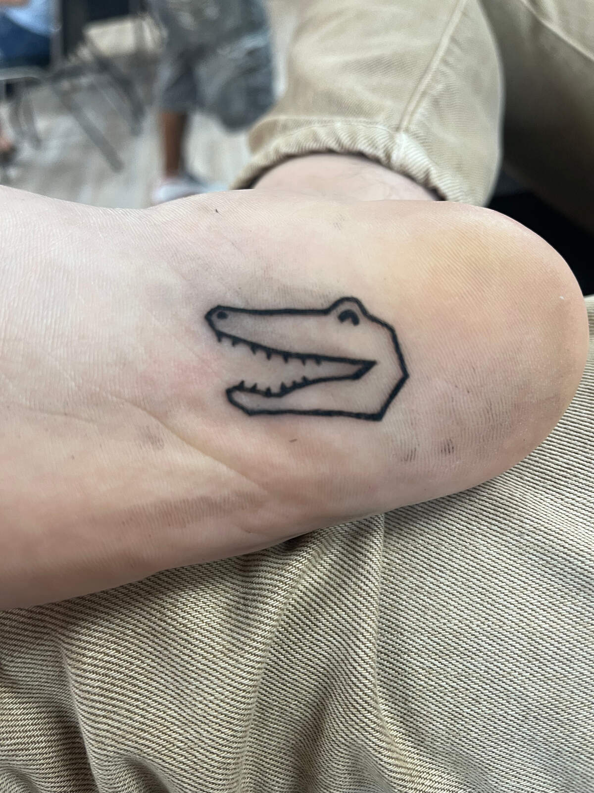 All team members of Gator Bait had a quarter-sized alligator head tattooed on their person. Justin Mankita, pictured, had the bottom of his foot foot tattooed with the smiling alligator head.
