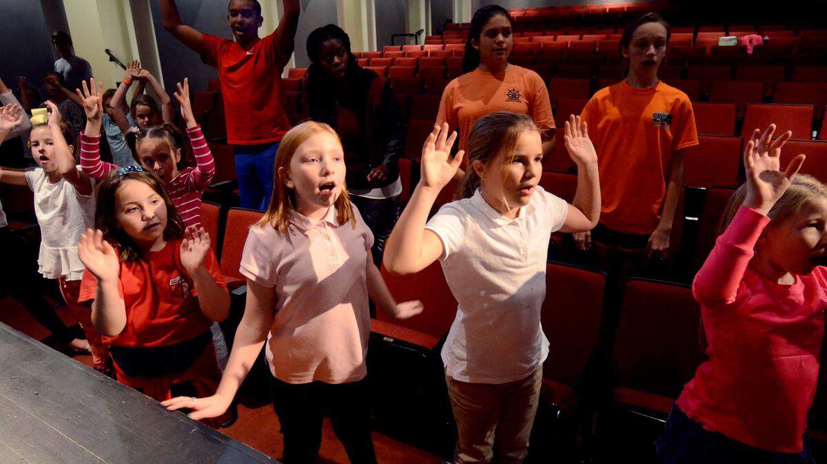 Young members of the large cast warm up with some dramatic exercises during rehearsal for Peter Pan at the USCB Center for Performing Arts on Thursday.