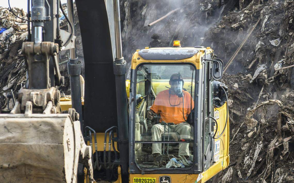 An unidentified worker wearing a gas mask operates a full-sized excavator on Wednesday morning at Able Construction’s Material Recovery Center in Jasper County just outside Hardeeville town limits to break-up the material to move to a landfill. The S.C. Department of Health and Environmental Control and the U.S. Environmental Protection Agency have begun cleanup of the towering 45-foot debris pile after at least one air born toxin was found.