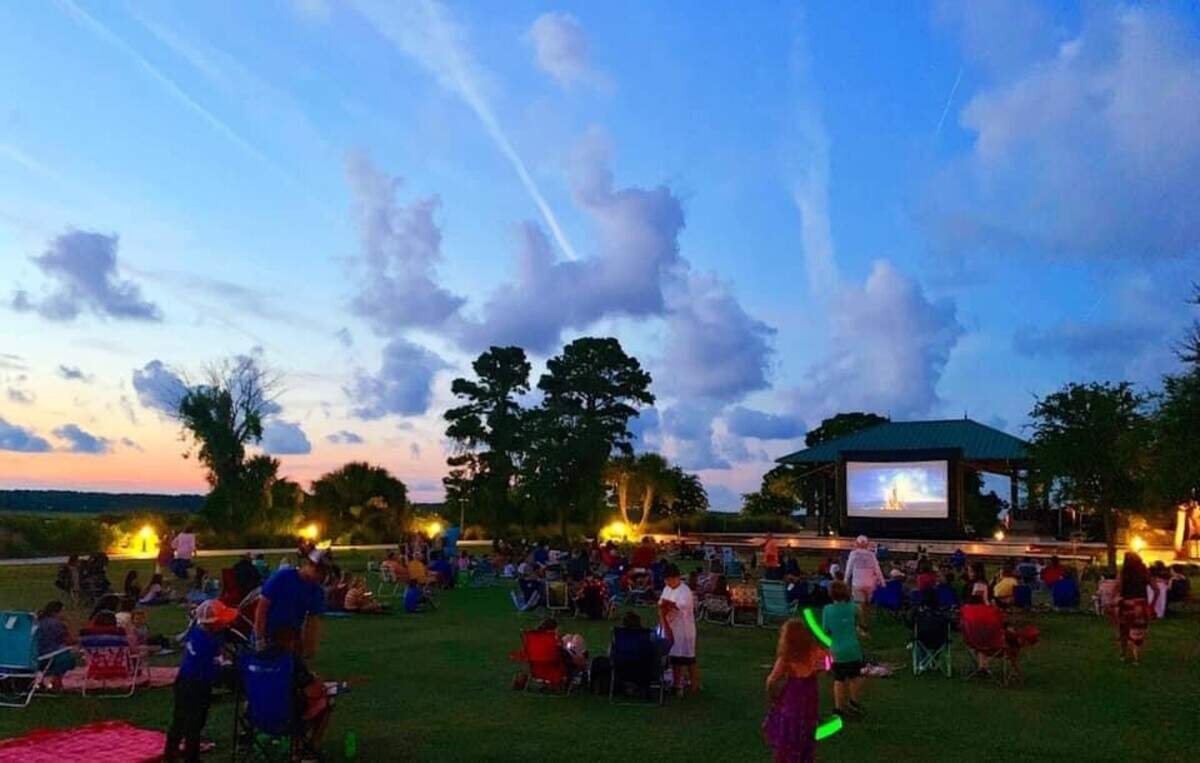 Families gather ‘round the big screen in Shelter Cove Community park to watch a movie.