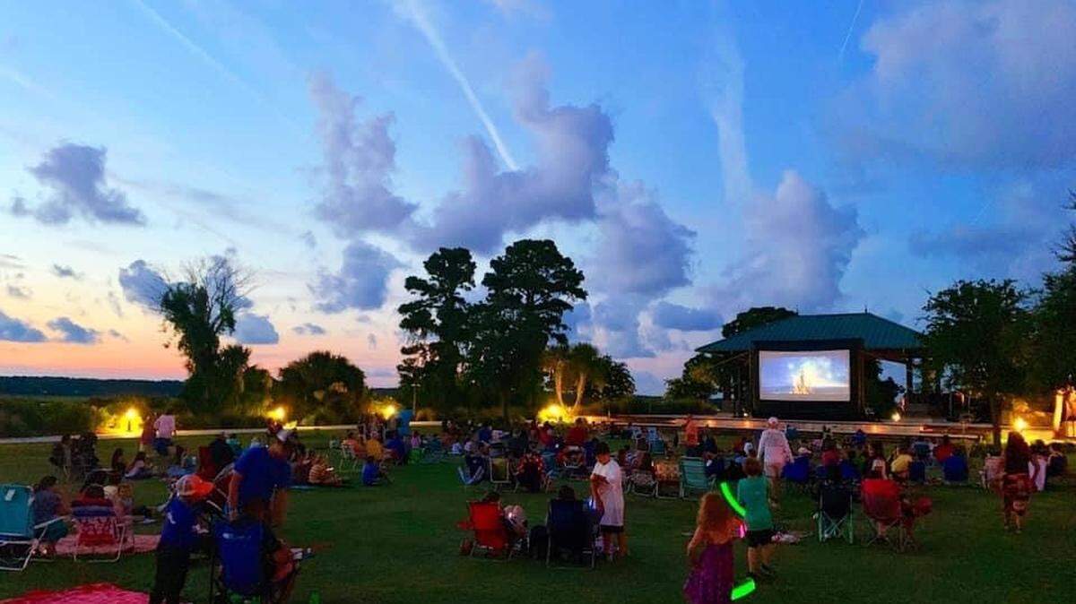 Families gather ‘round the big screen in Shelter Cove Community park to watch a movie.