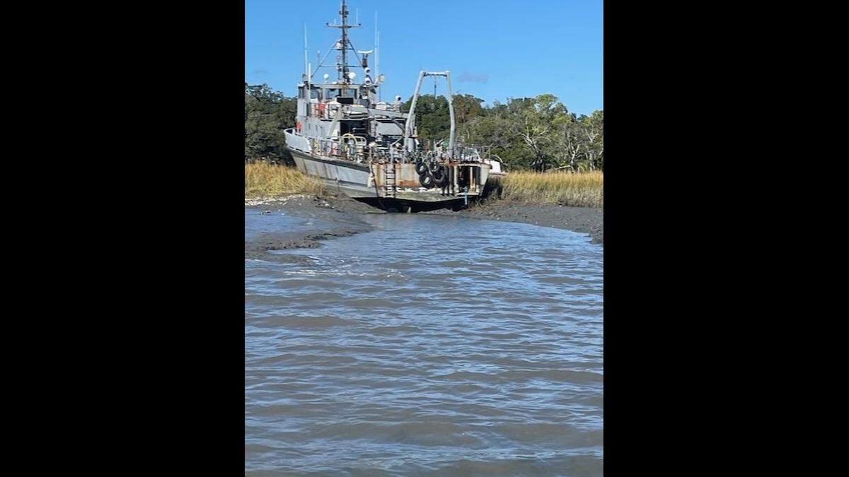 This 120-foot-long former Navy torpedo vessel is stuck in the mud outside of Charleston. Its owner has been arrested under the state’s new abandoned boat law.