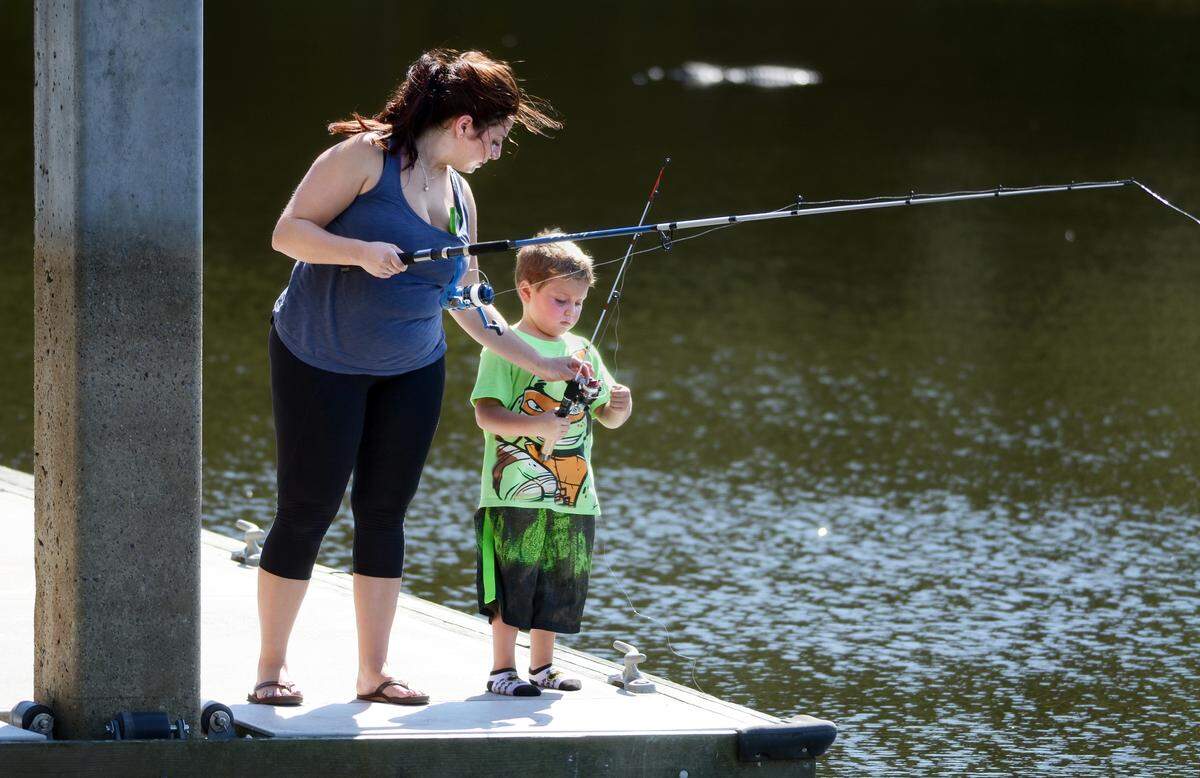 Hilton Head Islander Celeste Iannazzo helps her son Rocco, 5, untangle the line on his new pole while fishing from the dock at Jarvis Creek Park on Monday. “We didn’t catch any fish, but we caught a turtle,” said Celeste of the after-school outing.