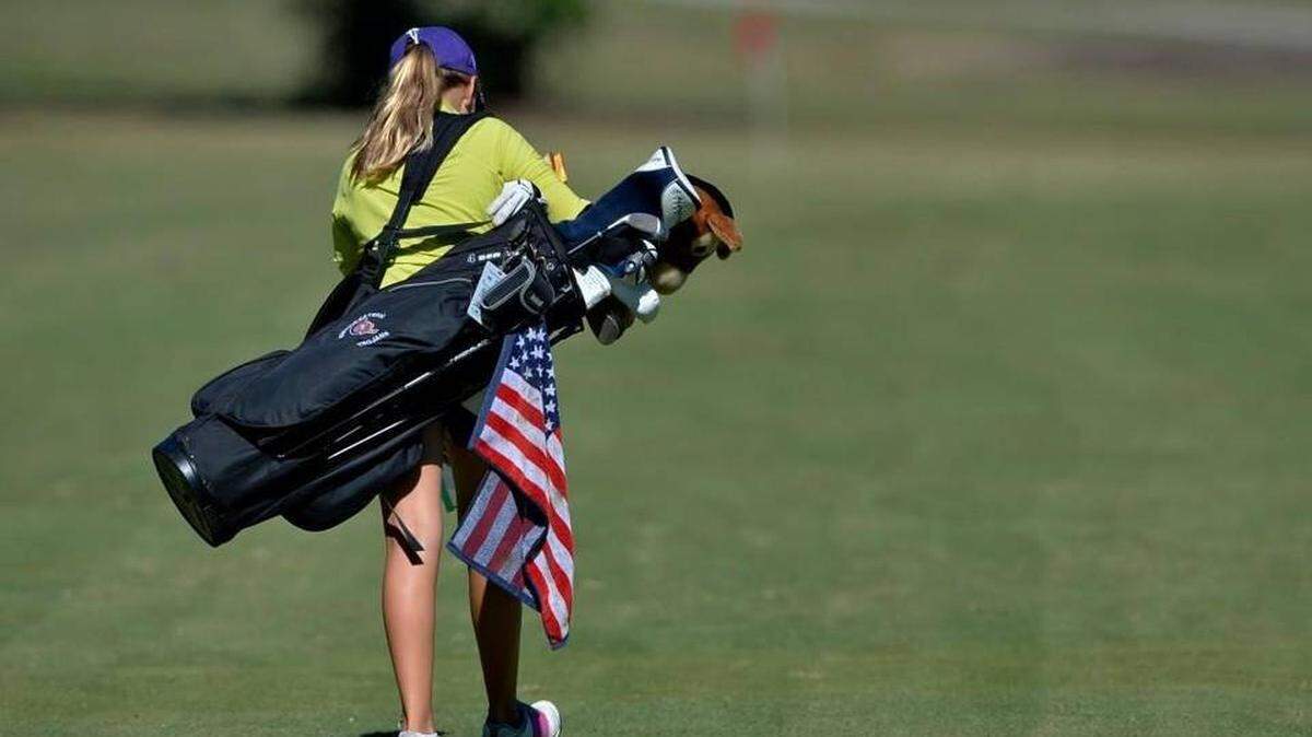 Buggy Reinke, a student at Northwestern High School in Rock Hill, SC, walks down a fairway (with her American flag towel, during the AAAA Upper State golf tournament Oct. 19 in Simpsonville. Buggy who has only been playing golf for less than a year, plays in honor of her father Staff Sgt. Gavin B. Reinke who died in Iraq on May 4, 2006.