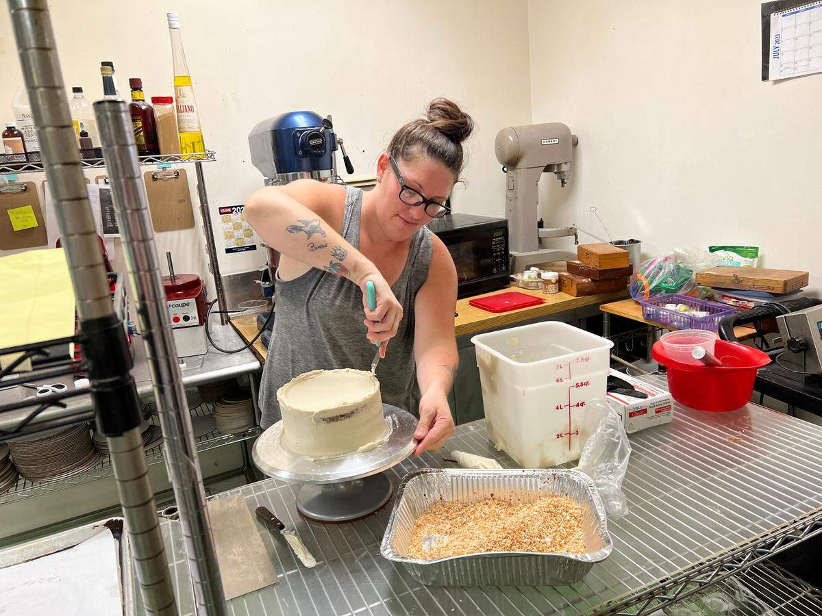 Baker Caitlin Anderson decorates a cake at Sprout Momma Bakery on Hilton Head.