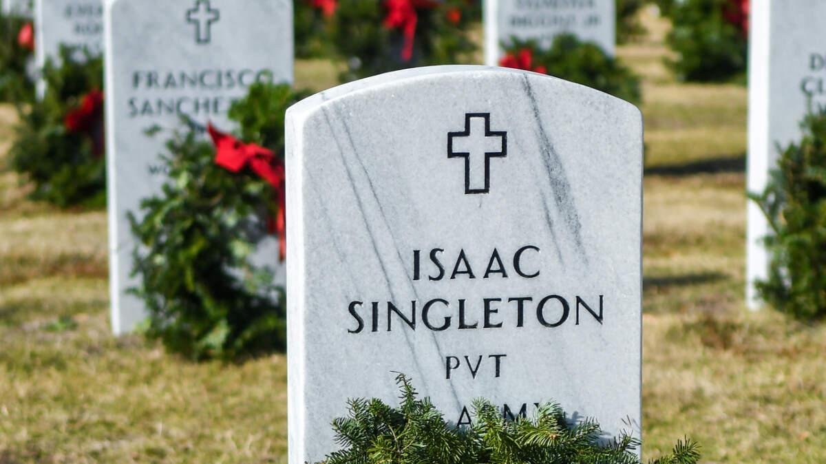 The grave of Isaac Singleton, a private in the U.S. Army who served in World War II and died in October, 2008 is decorated with a ‘remembrance wreath’ as well as the entirety of the cemetery as part of Wreaths Across America Beaufort at Beaufort National Cemetery.