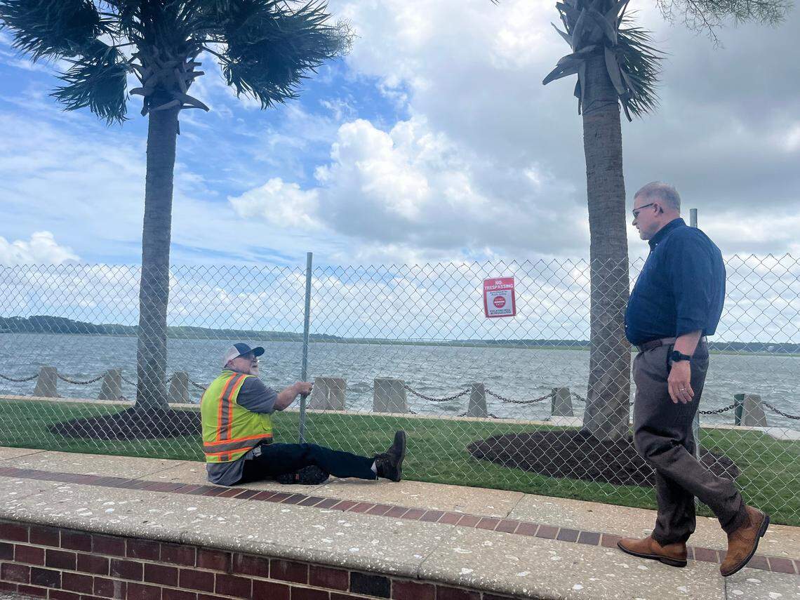 Beaufort City Manager Scott Marshall greets Joe Ciccone of Public Works as he works on a fence that has been erected to keep the public from accessing the promenade along the Beaufort River. “It wasn’t a fun decision,” Marshall said of the move to close the popular promenade. 