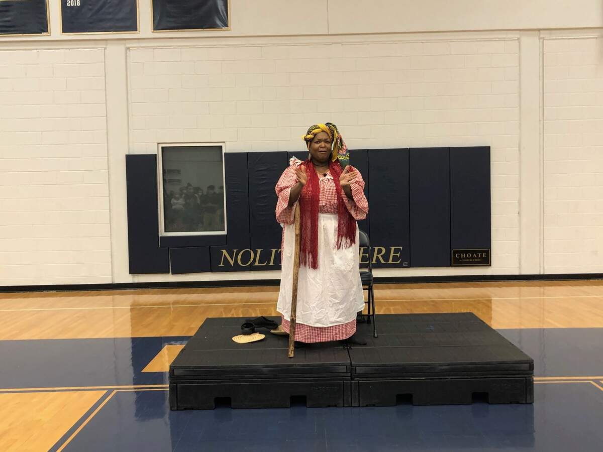 Anita Singleton-Prather leads the audience in song at John Paul II Catholic School in Ridgeland, S.C.