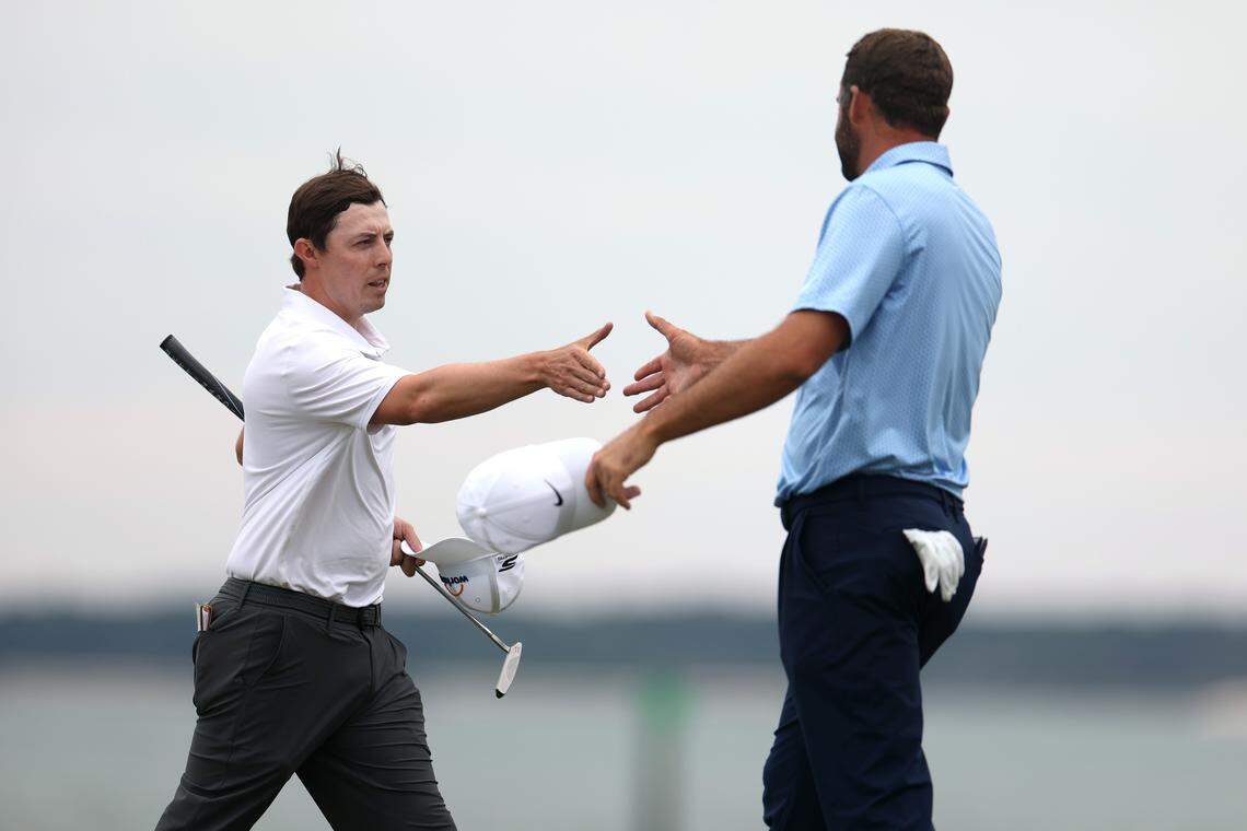 Matt Fitzpatrick of England and Scottie Scheffler of the United States shake hands on the 18th green before a playoff during the final round of the RBC Heritage 2026 at Harbour Town Golf Links on April 19, 2026 in Hilton Head Island, South Carolina.