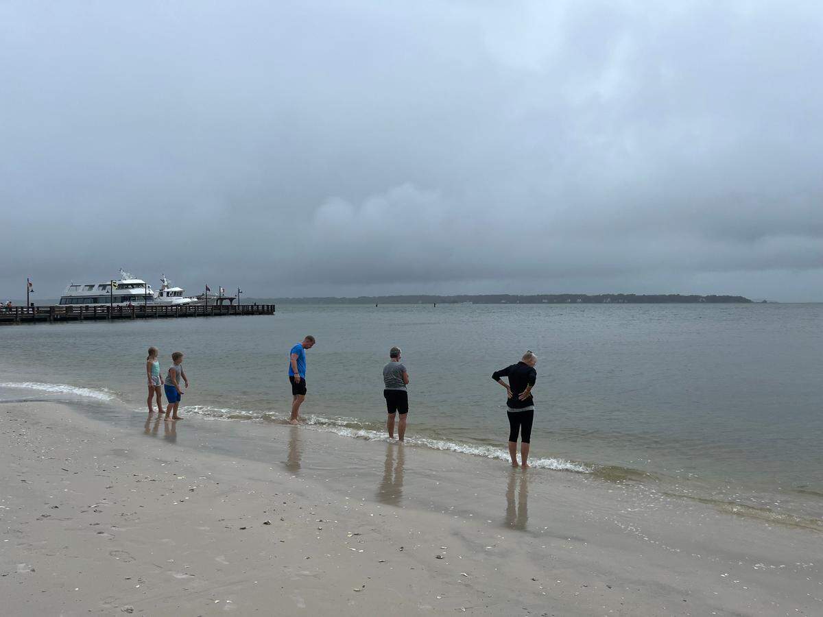 People gathered on the shoreline at Sea Pines on Hilton Head Island, South Carolina, Tuesday, Aug. 6, 2024.