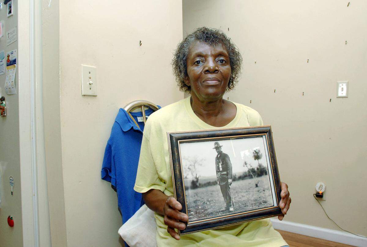 Thelma Byas, sits in the partially dismantled dining room of her home, holding a photograph of her great grandfather, Matthew Jones, who originally purchased the land she lives on. A recent sale of the heirs property, located in the Stoney community, to the Town of Hilton Head Island has meant Byas and several of her relatives are being forced to move from the land they have lived on all their lives. "I don't know where I'm going," Byas said. "It's hard, it's really hard."