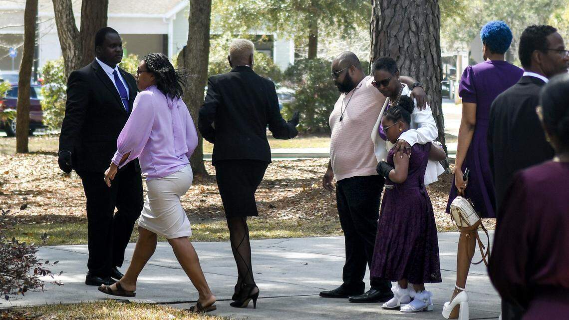Consweulo Davis, embraced by family, waits to enter St. Peter’s Episcopal Church on March 7, 2026, to celebrate her wife Linda Davis’ life on Skidaway Island.